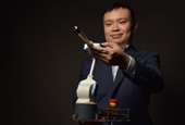 At Arm's Length—Darwin Lau flexes his robotic arm in teaching