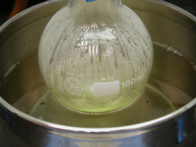 very close-up image: Heating the reaction mixture