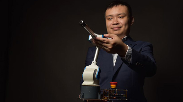 At Arm's Length: Darwin Lau flexes his robotic arm in teaching