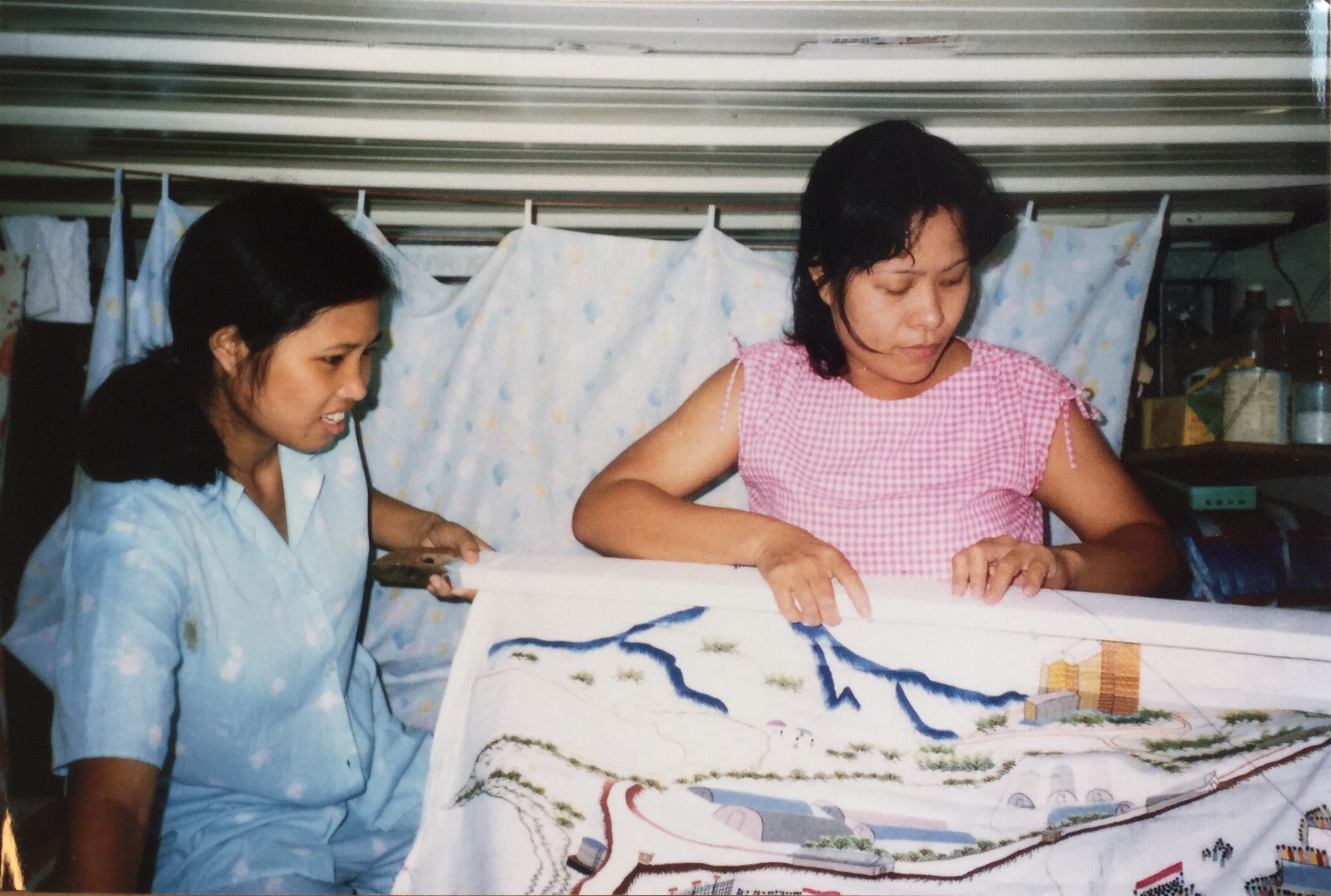 The process of women weaving artworks inside the detention camp.