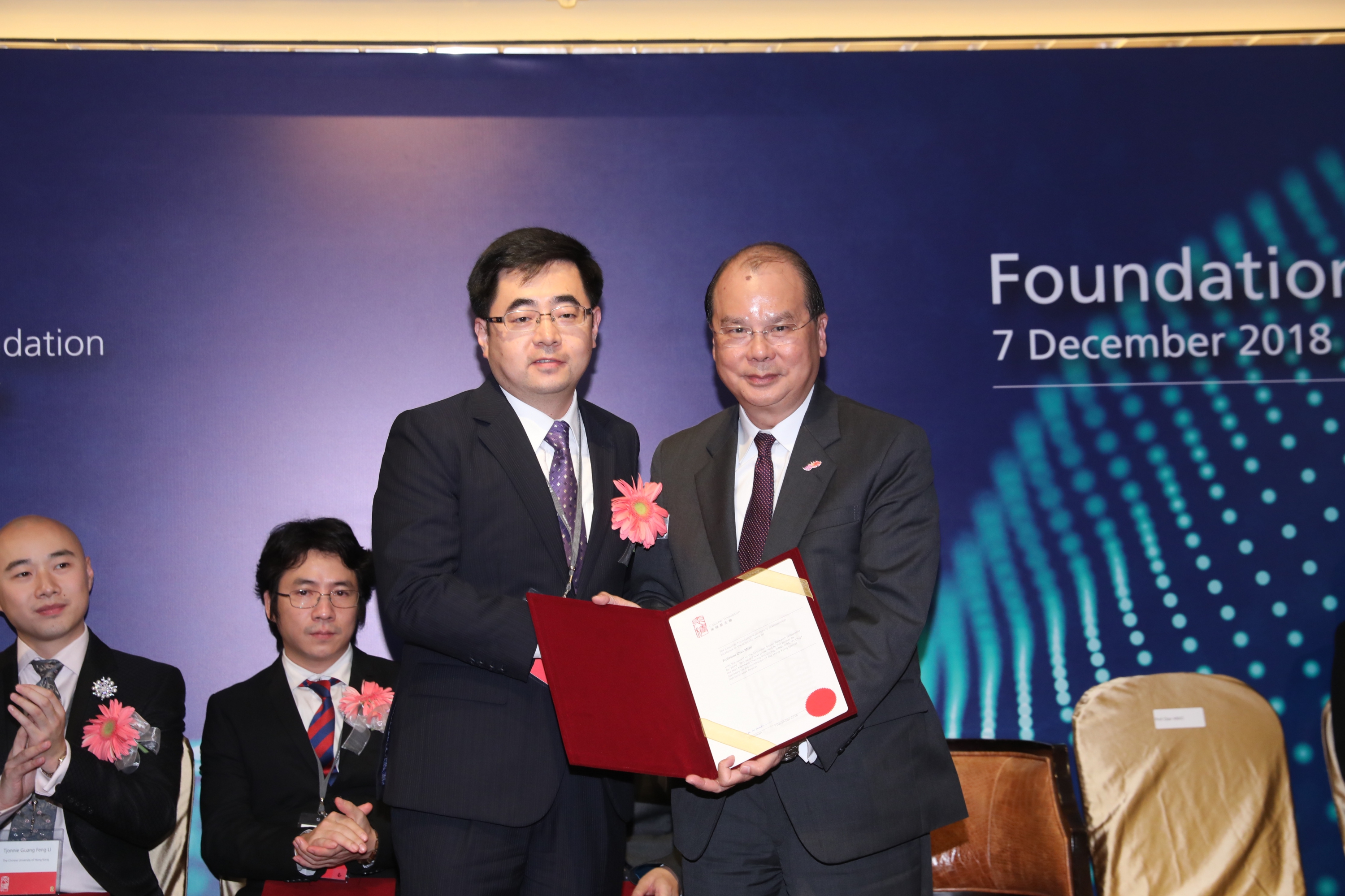 The Honorable Matthew Cheung (right), presents the Croucher Senior Research Fellowship 2019 to Prof. Qian Miao.