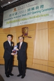 Prof. Lawrence J. Lau (right) presents a souvonir to Mr. Edward Yau .