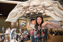 Visitors looking at a model on display at the Alumni Exhibition.