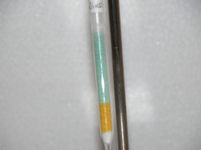 close-up image: two third of the orange acidified dichromate(VI) ions on silica gel changed into blue chromium(III) ions