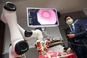 Professor Philip CHIU demonstrates the endoscopic deployment of the microrobots in a human body model. The magnetic field actuation outside the model endows high-precision delivery of the microrobots to the target location.