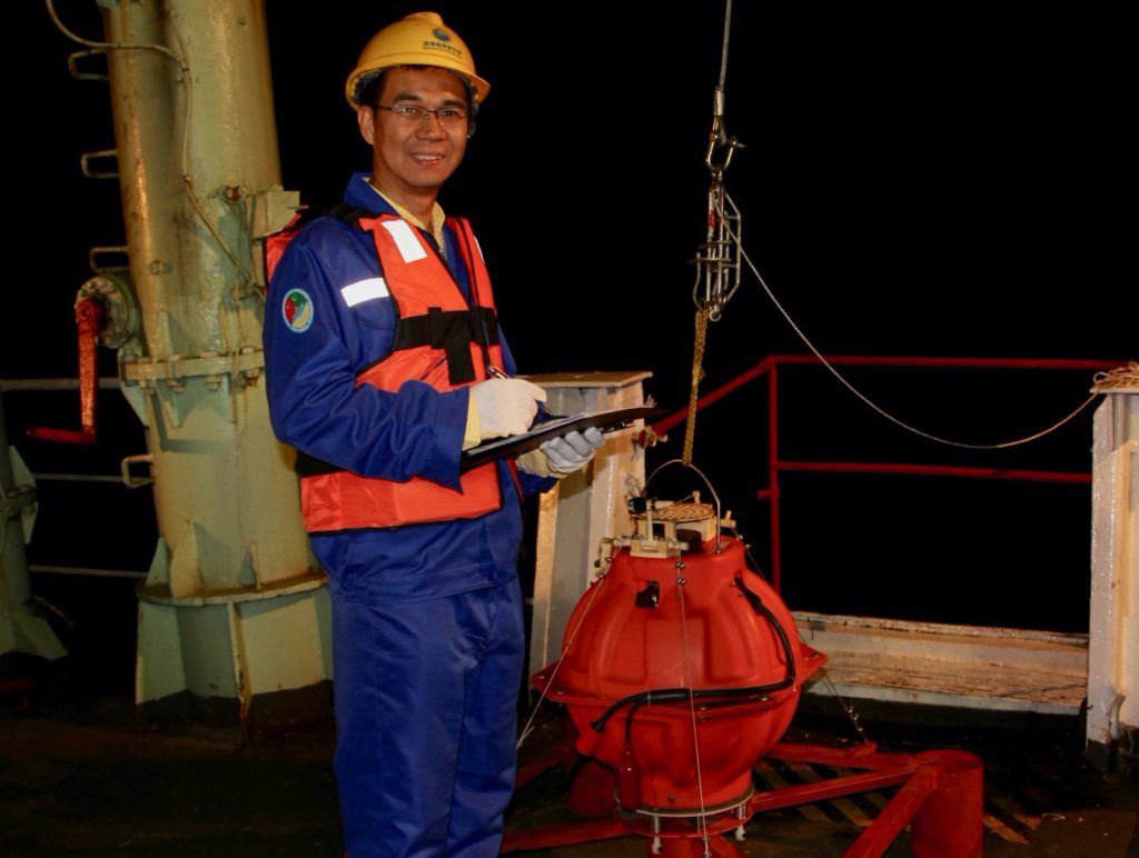 Professor Hongfeng Yang with an Ocean Bottom Seismometer during the first China-Pakistan Joint Expedition in 2018 to investigate potential earthquakes and tsunami along the Makran Trench in the Indian Ocean.