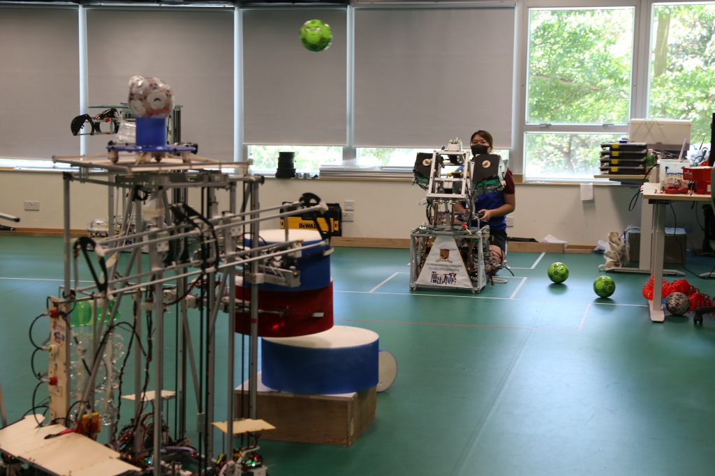 During internal practice matches before the contest, students have identified weaknesses of their robots and come up with new tactics to reach new heights.