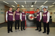 Professor K.C. Chan (2nd right) hits the gong to open the finance trading laboratory at CUHK