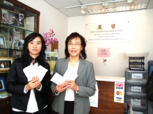 Prof. Suzanne C Ho (right) and Ms Liu Zhaomin holding samples of protein supplement to be used in the Centre's latest research programme.