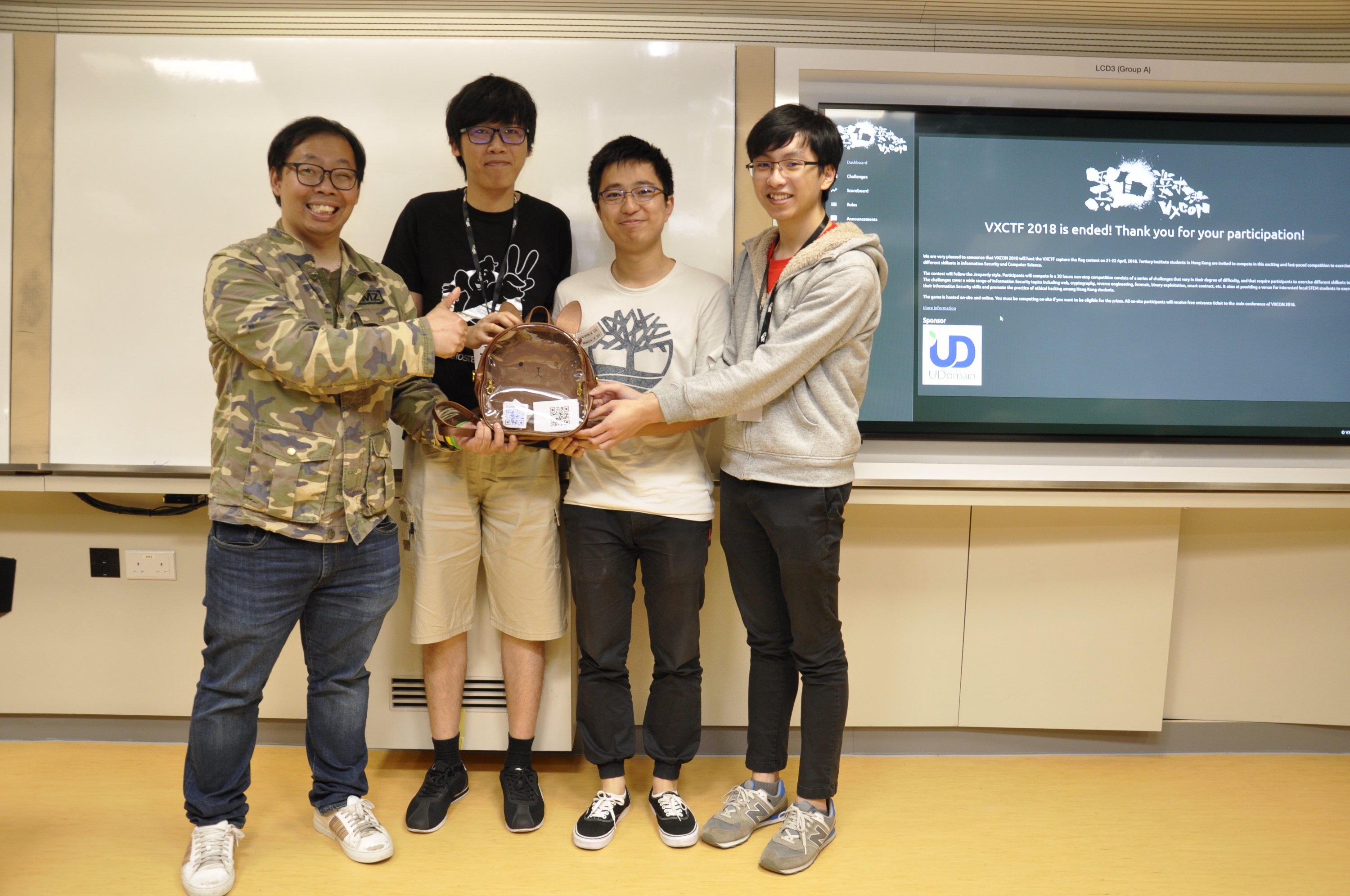 (From 2nd left) Cham Fei TONG from the Department of Computer Science and Engineering, Yihui ZENG from the Department of Mathematics, and Shing Yuet LEUNG from the Department of Information Engineering beat the other ten teams from four tertiary institutions to win the championship in the VXCTF 2018.