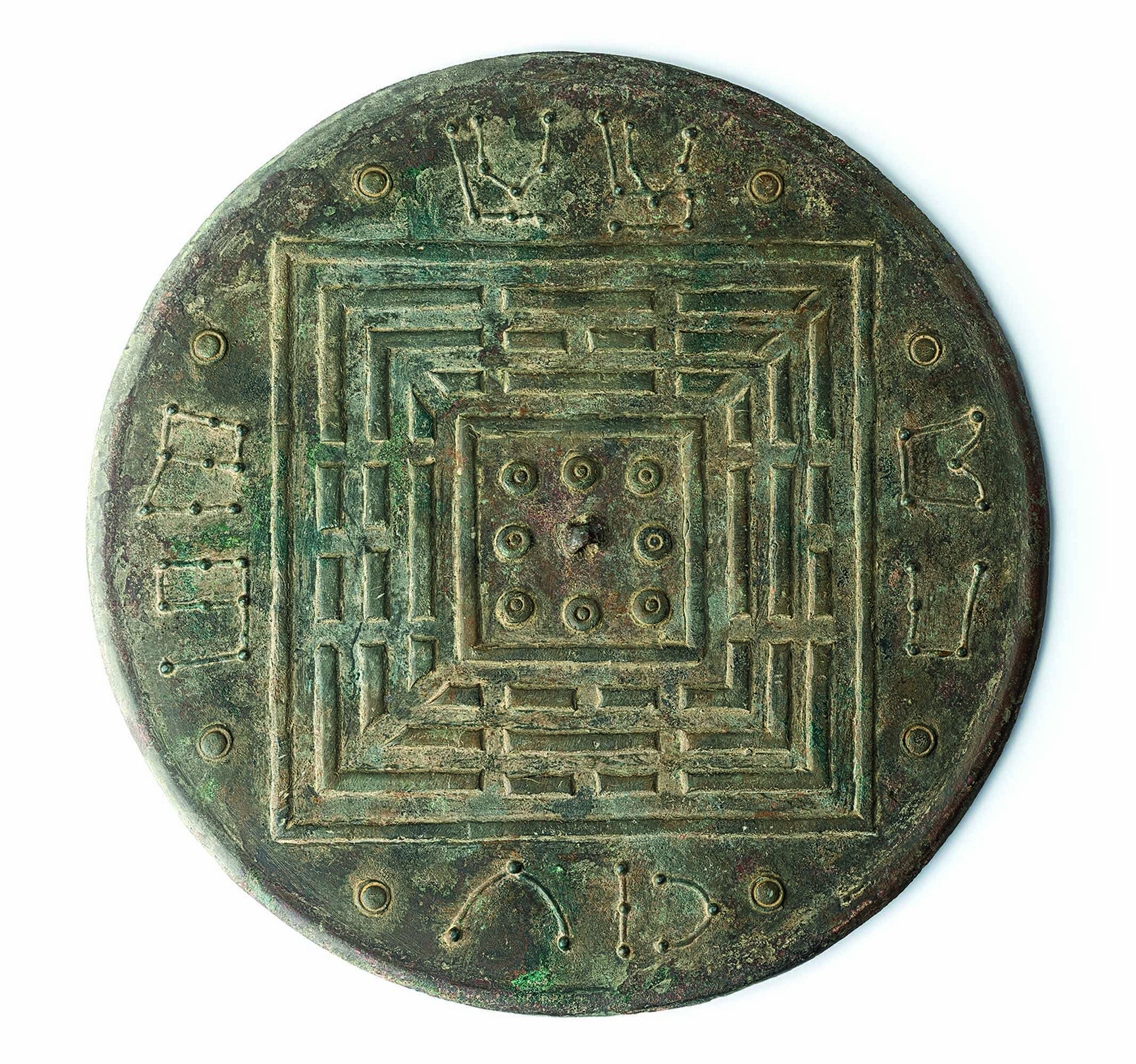 Mirror with patterns of the eight trigrams and unknown constellations
Late Tang to Song, 10th–14th cent.
Diam. 21.9 cm, rim h. 0.29 cm, w. 625 g
Art Museum Collection 
Gift of Prof. MARK Kai-keung

Mark’s mirror has integrated the patterns of the houtian eight trigrams and constellations, in a manner that invites further investigation. There are eight knobs on the knob seat, plus a ninth one that is actually the loop of the mirror. The outer rim contains the houtian eight trigrams, while the outermost rim houses some unknown constellations, which are not the twenty-eight constellations we are familiar with.  They are probably mysterious constellations constructed in some Daoist apocrypha.