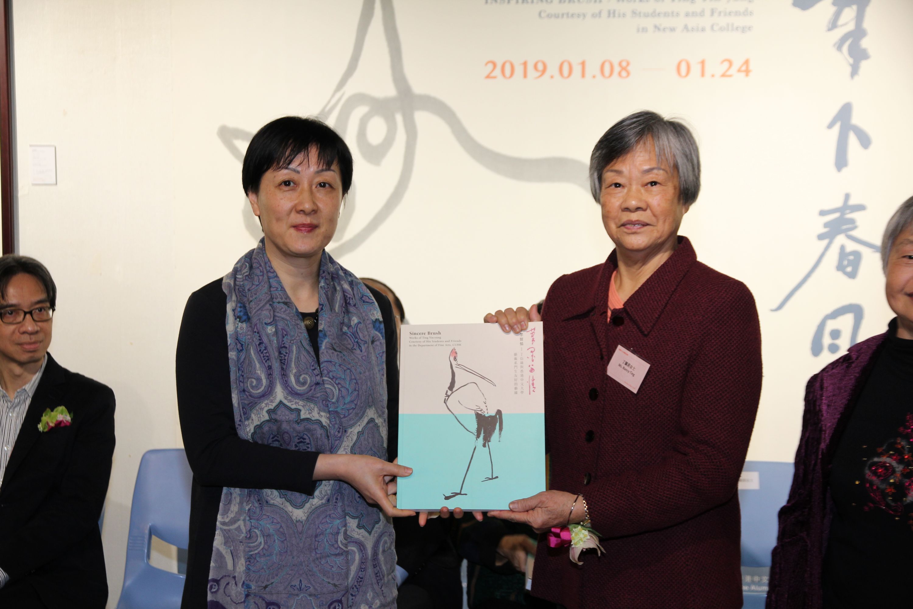 Prof. Xu Xiaodong, Associate Director of the Art Museum, CUHK presents a souvenir to Ting Lan-sai, a daughter of Ting Yin-yung.