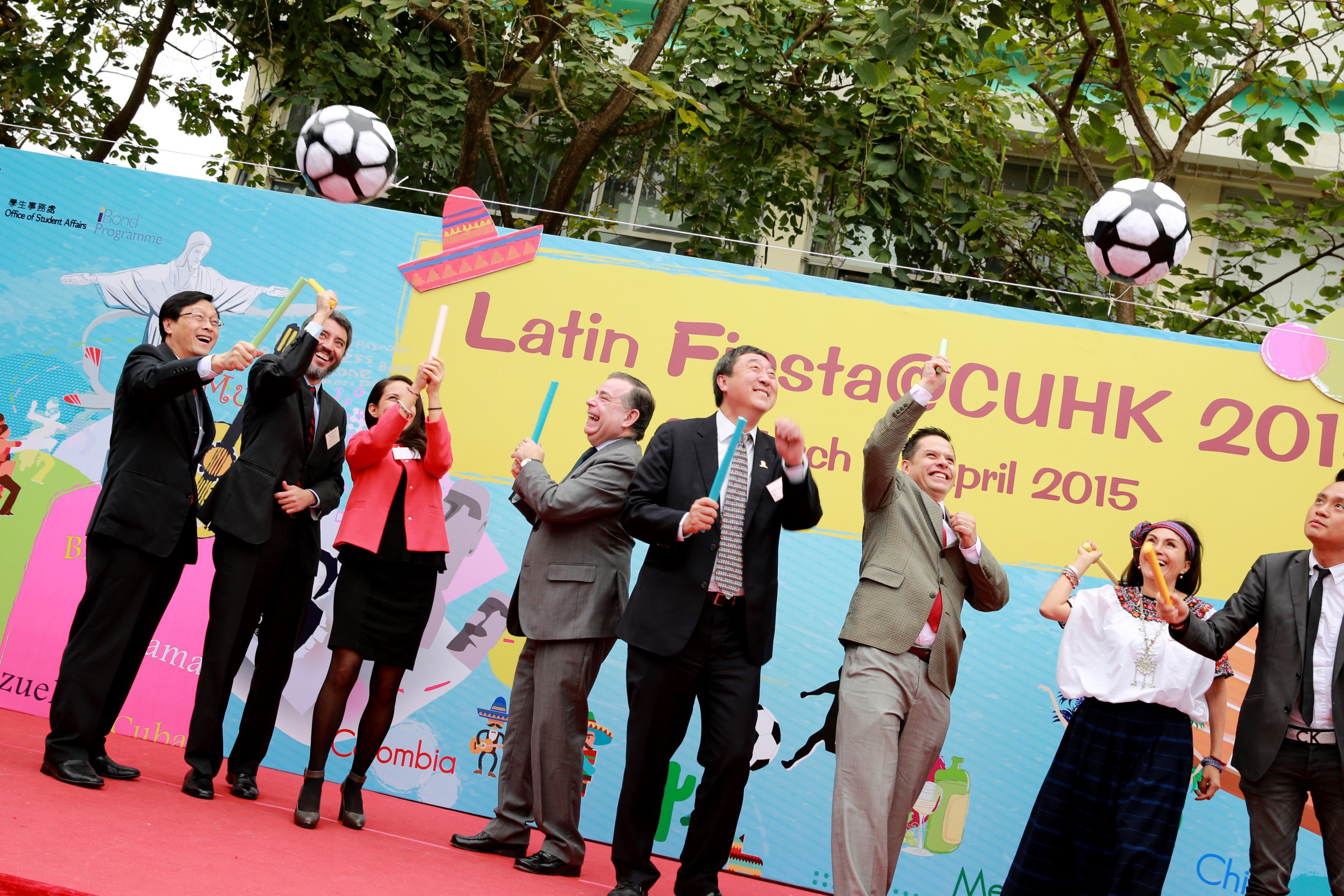 The guests have fun hitting the football piñatas.