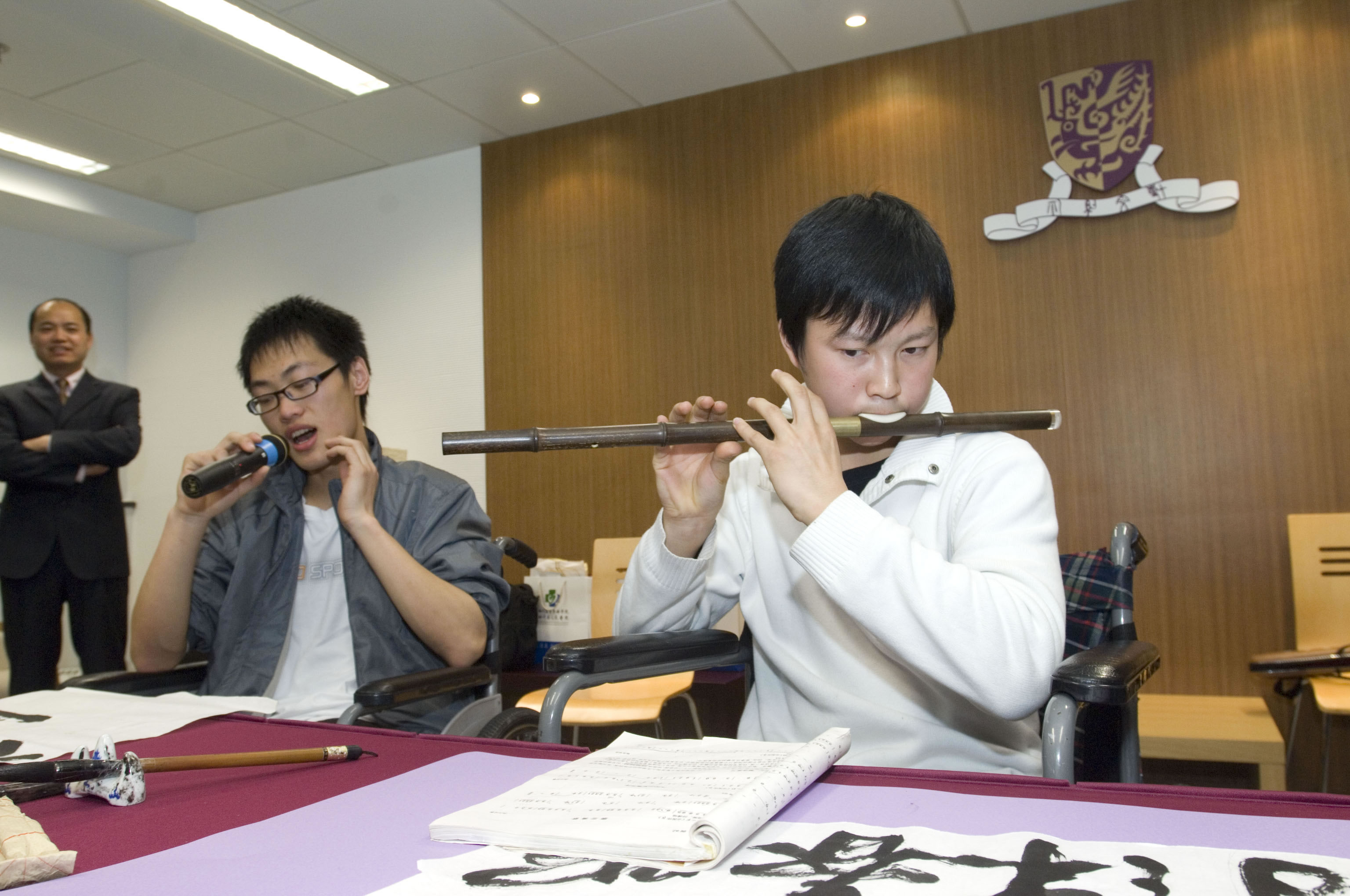 Dai Guo-hong is playing bawu while Gong Gui-lin sings