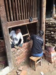 Students laying bricks