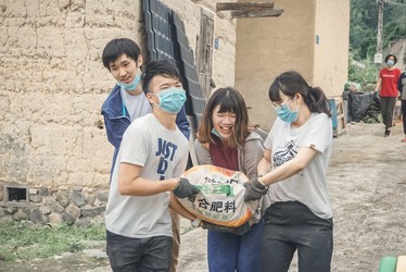 Students carrying cement