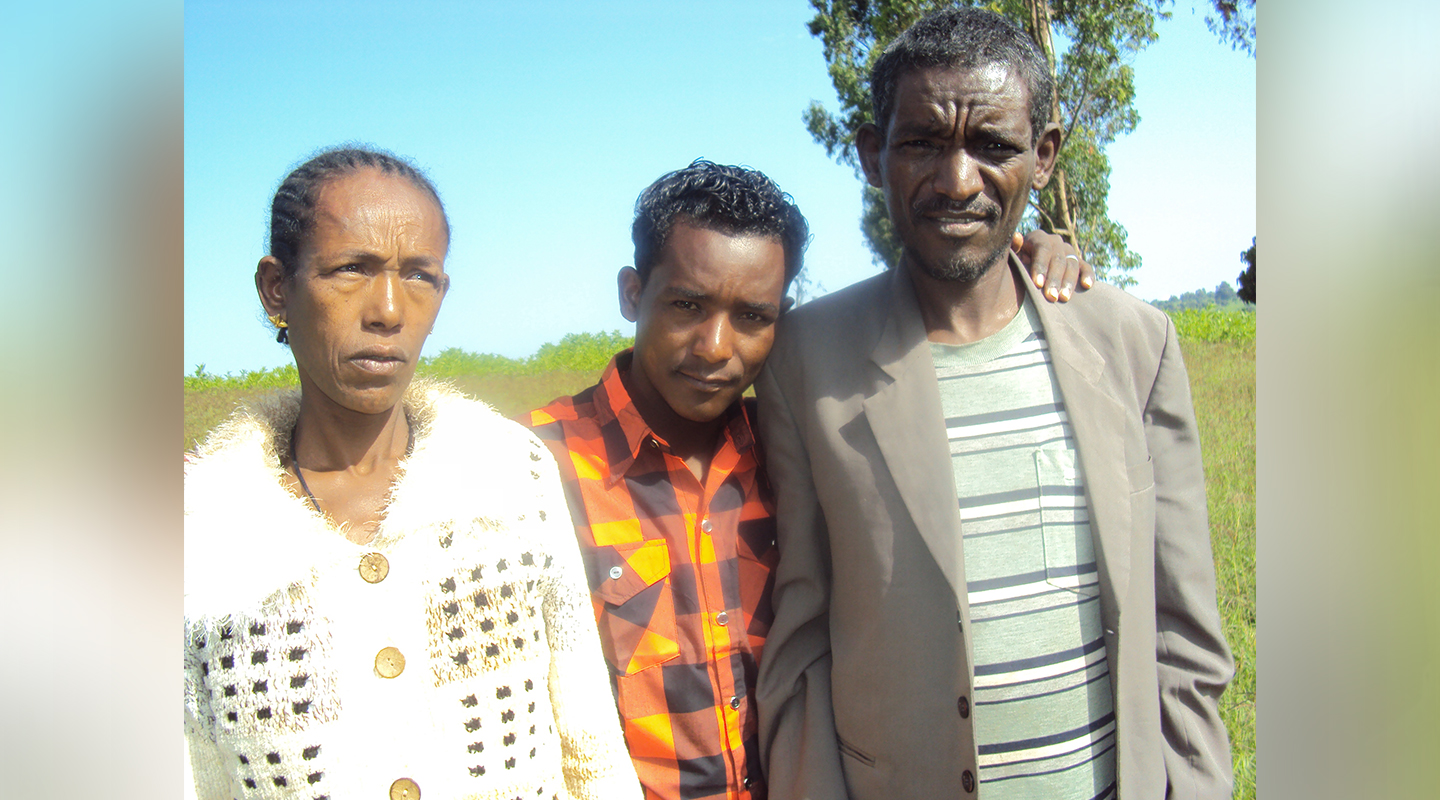 Ginenus <em>(centre)</em> with his mom <em>(left)</em> and dad <em>(right) (courtesy of interviewee)</em>