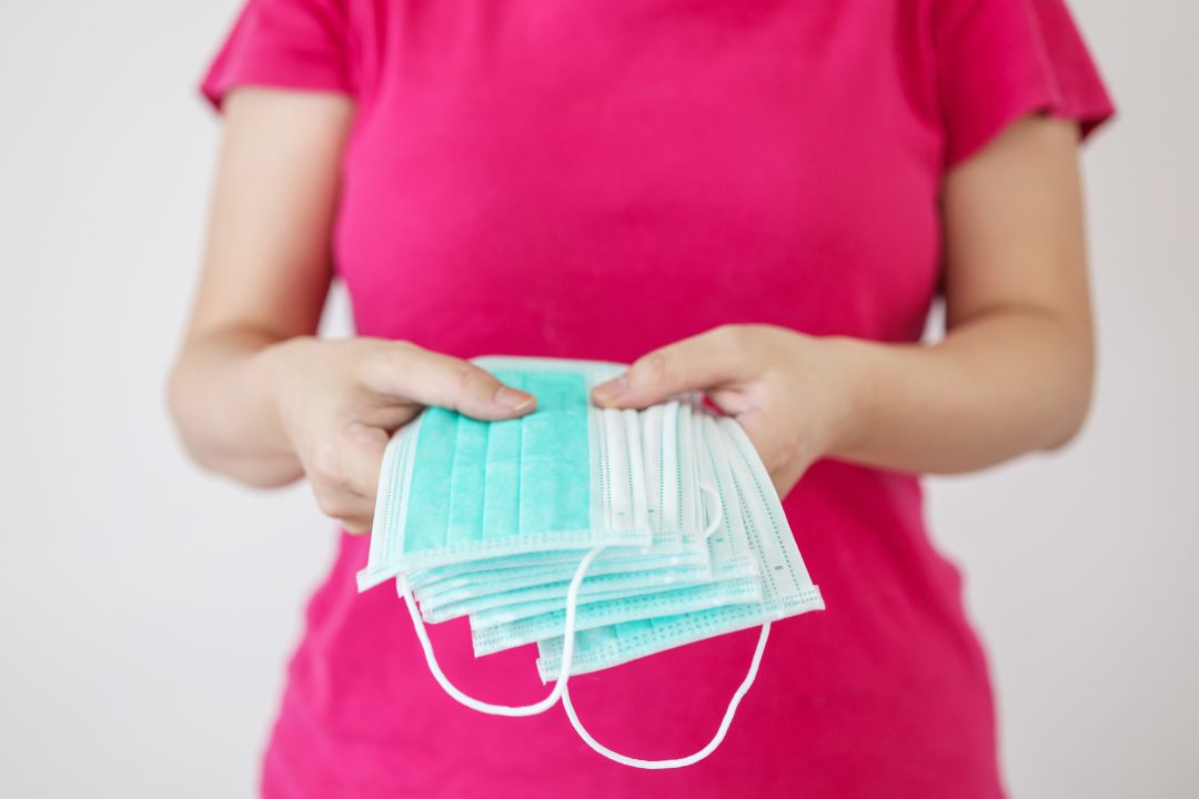 Woman hold surgical face mask on hands