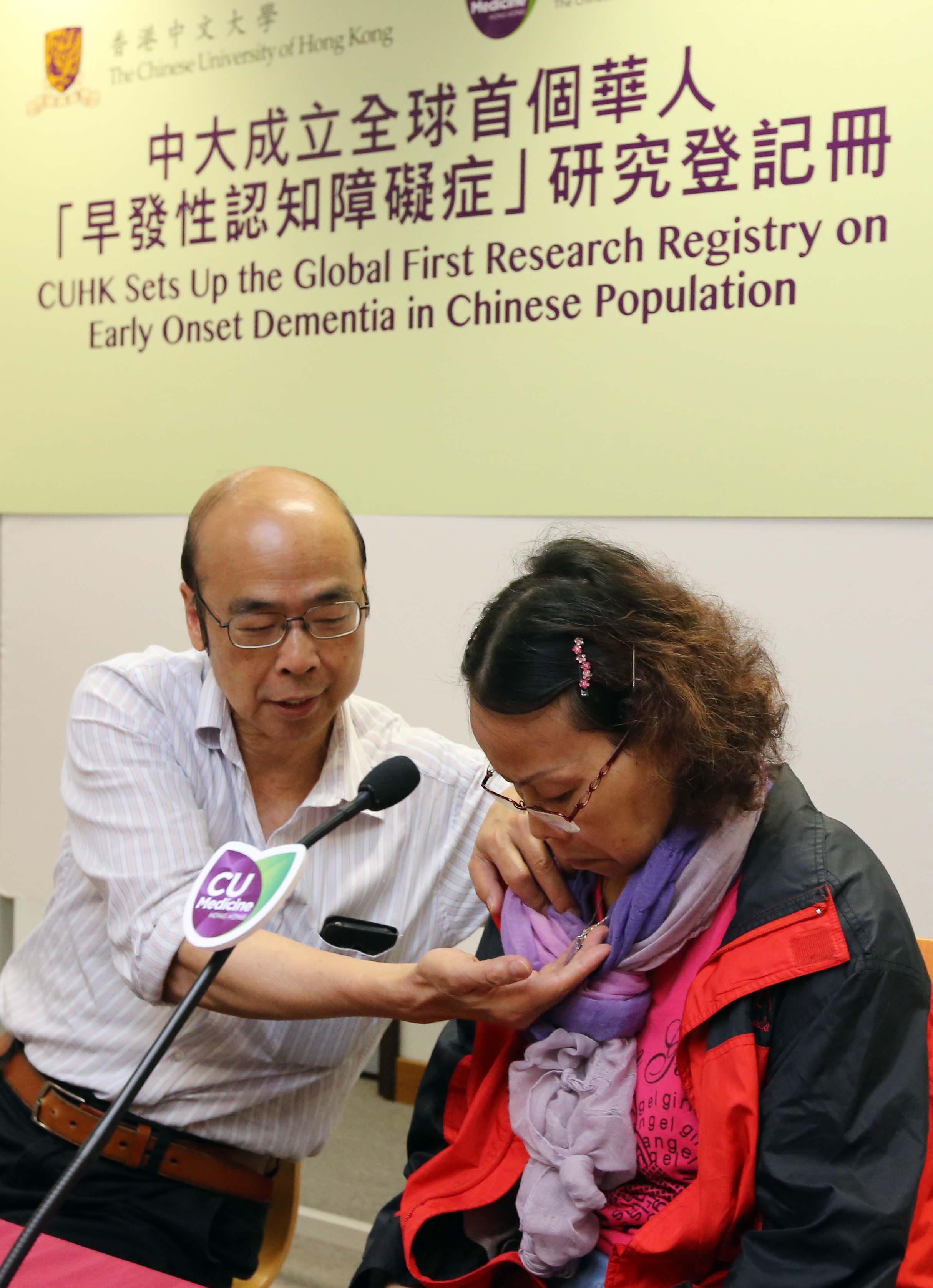 Mr. Yeung shows the name tag he prepared for his wife who is suffering from early onset dementia, to avoid her from getting lost.