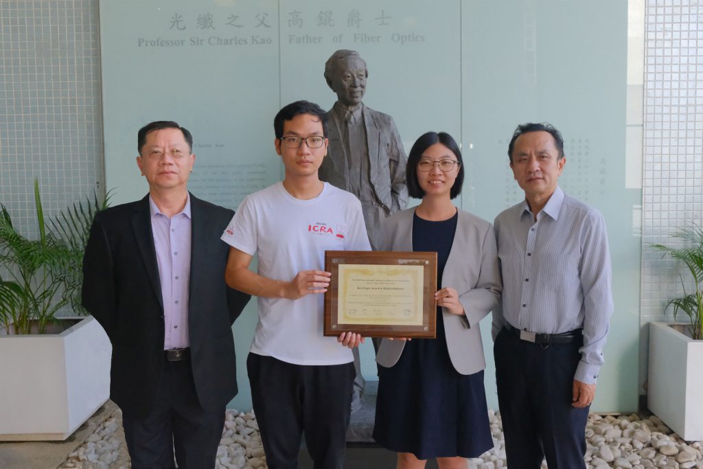 Professor Qi DOU (2nd right), Professor Pheng Ann HENG (1st left), Professor Yunhui LIU (1st right) and PhD student Yonghao LONG (2nd left) .