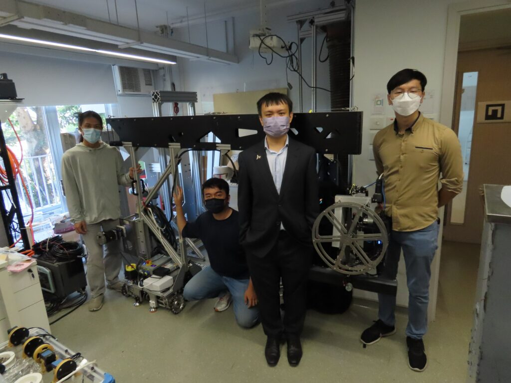 The research team led by Professor Darwin Lau (2nd right) hopes the "Cable-driven Inspection Robot for High-rise Building Façade" can reduce the risk to workers from working at heights.