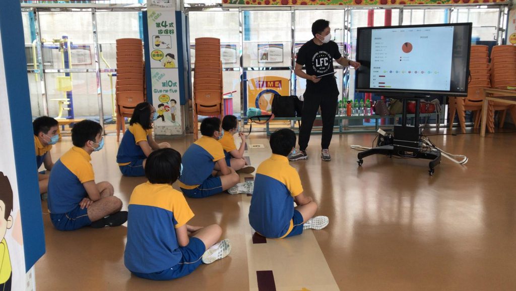 A physical education teacher keeps track of students’ activity levels during physical education lesson through the use of the Polar PE solution system and an interactive electronic white board.