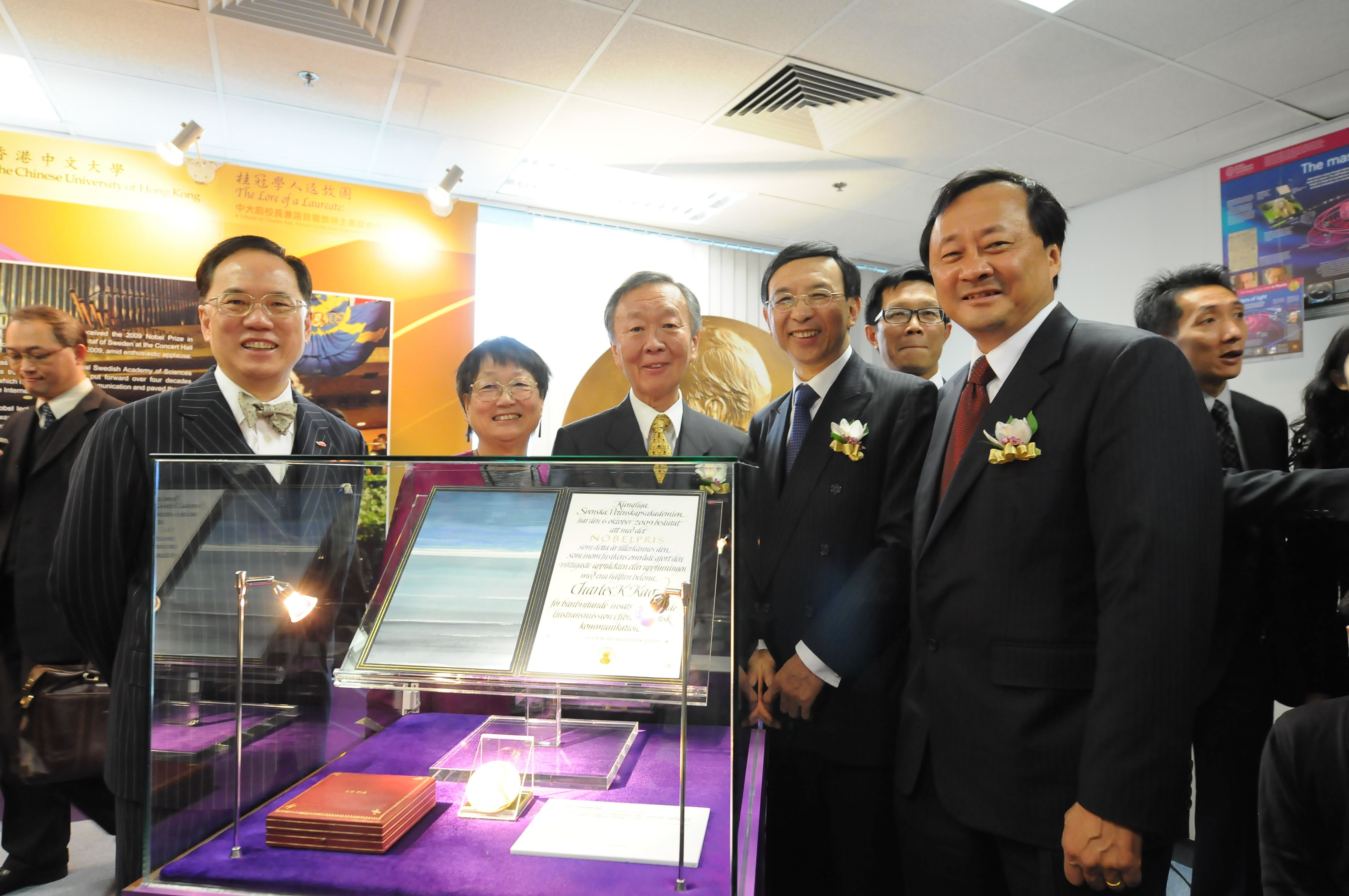 Officiating guests posing at the highlight of the exhibition: the Nobel Prize Medal and Diploma