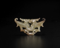 Jade double-phoenix pendant in openwork
Warring States Period
L: 4.8 W: 2.5 Th: 0.5 cm
Recovered from tomb no.2 at Jiuliandun, Zaoyang, Hubei province in 2002
Hubei Provincial Museum

Formed by two phoenixes facing towards the rectangular centre to form a bilaterally symmetrical pattern. The outline resembles the jade feline face from Shejiahe culture.