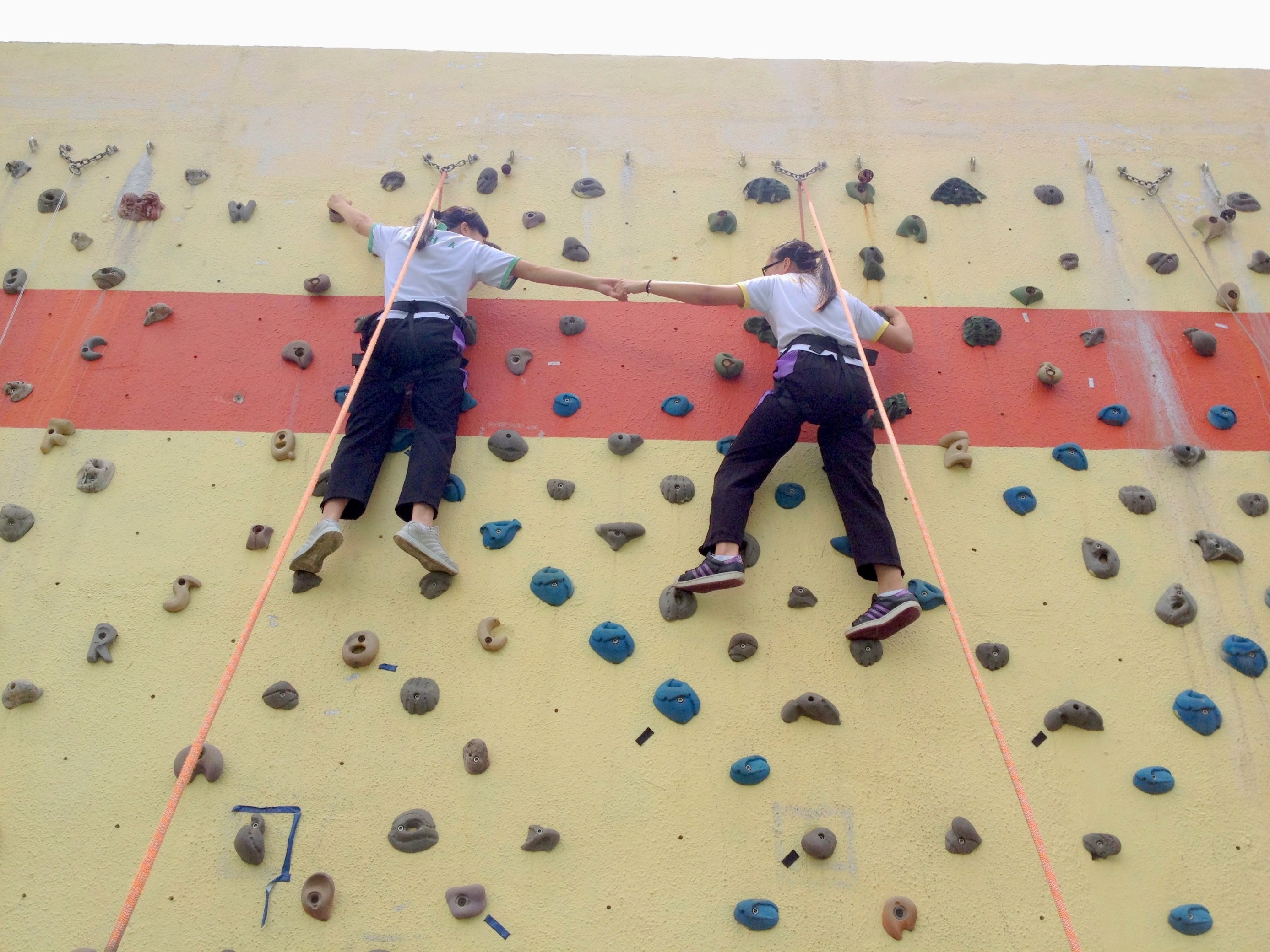 The beneficiary students learn to deal with challenges during the rock-climbing activities..