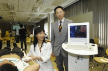 Prof. Henry Chan (right) and Dr. Grace Wong demonstrate the operation of Fibroscan