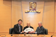 Prof. Joseph Sung (left) presents a paper fan with both Professor Jao's and his calligraphy printed to Professor Malmqvist.