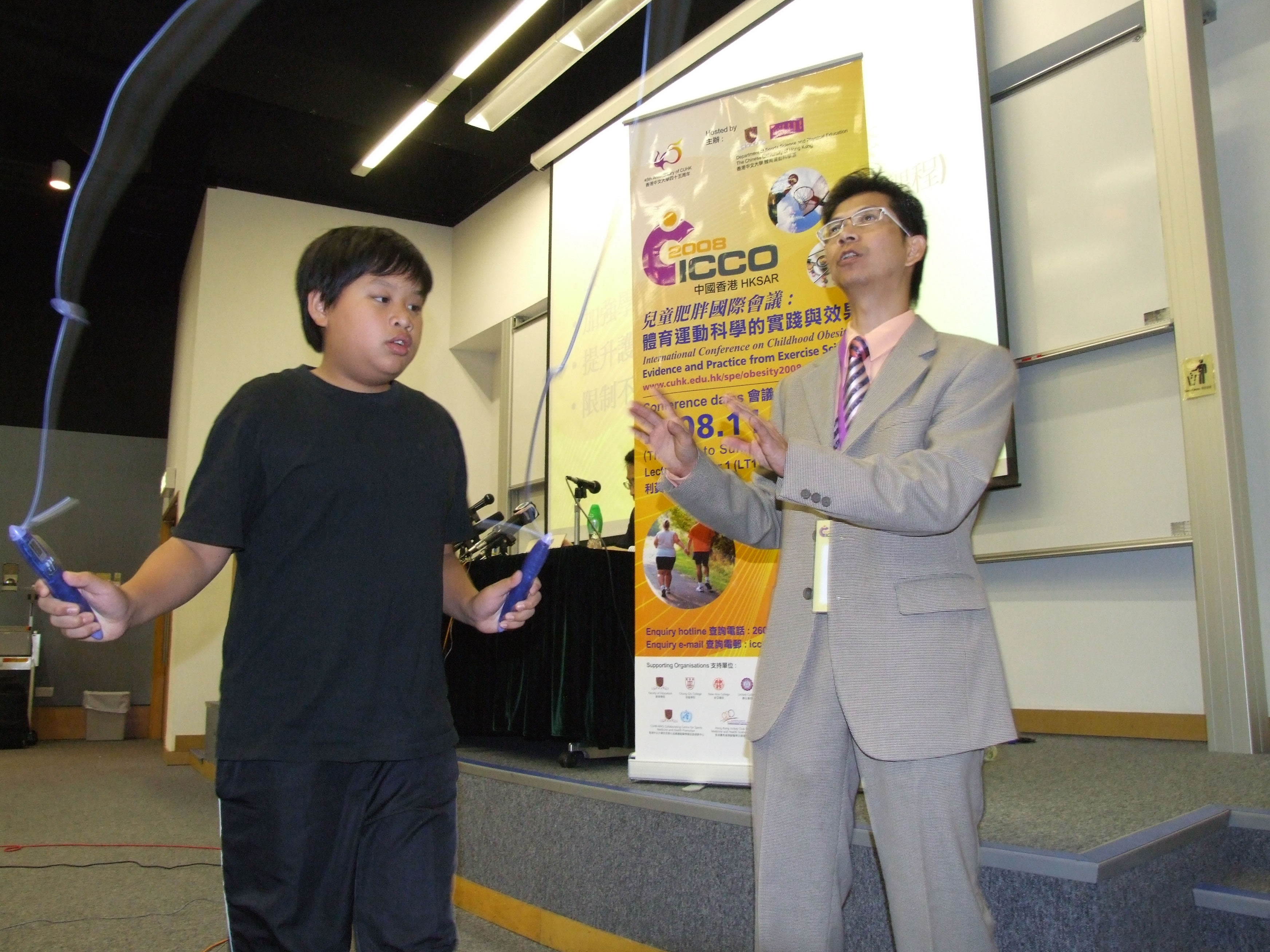 A boy demonstrating rope skipping using a special rope that shows energy consumption