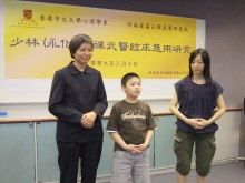 Mrs. Tsang (right) and her son demonstrating Dan Tian breathing with Prof. Agnes Chan