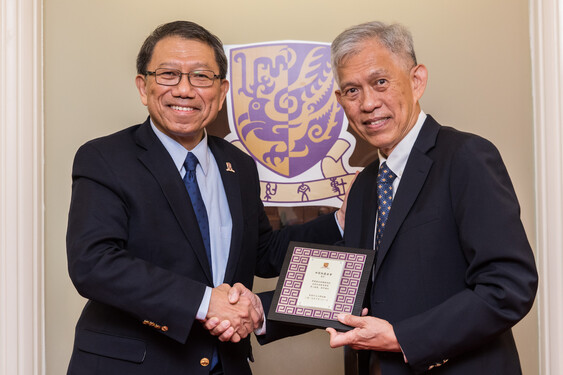 Professor Tuan presents a souvenir to Mr Tin.