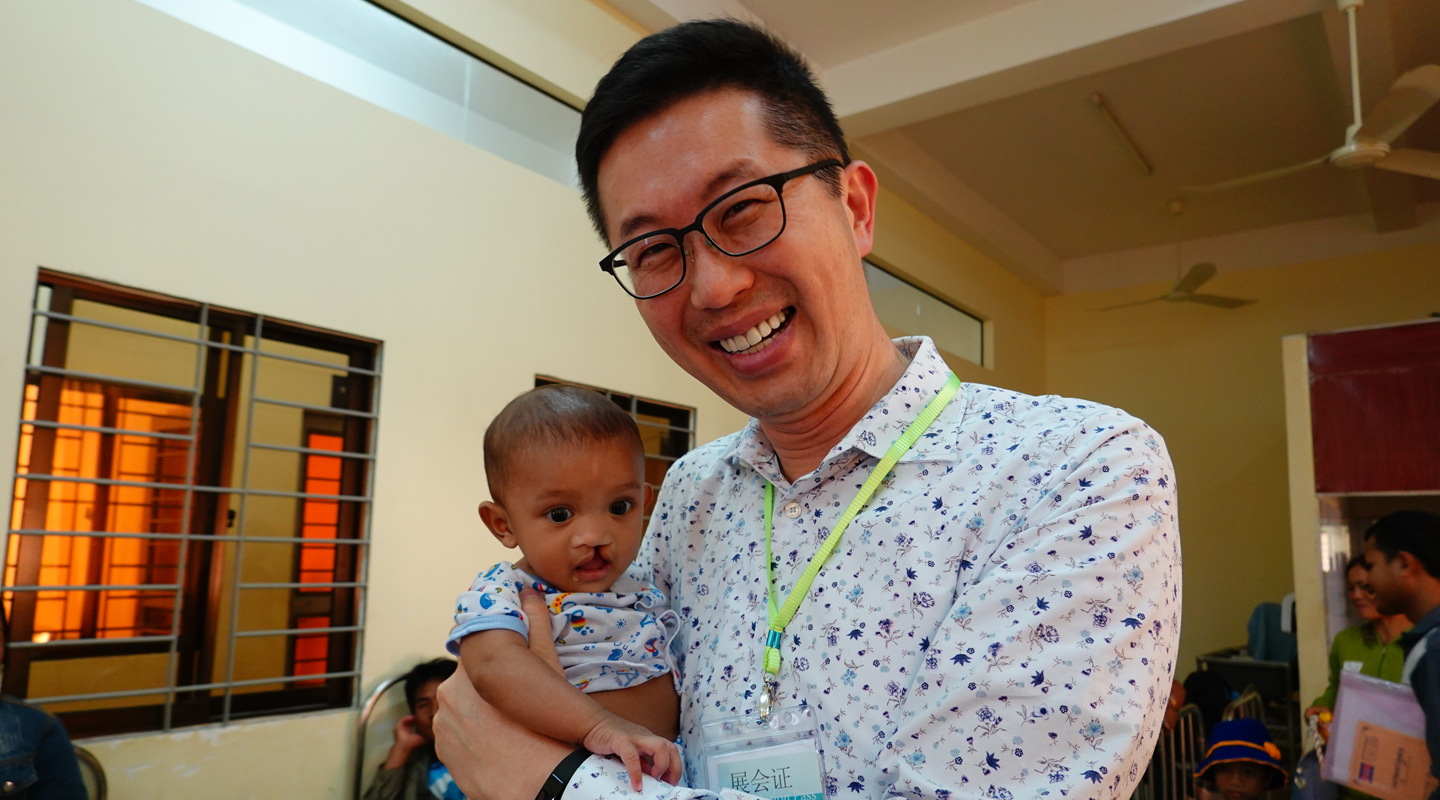 Dr. Peter Pang and a child with an orofacial cleft <em>(Photo courtesy of interviewee)</em>