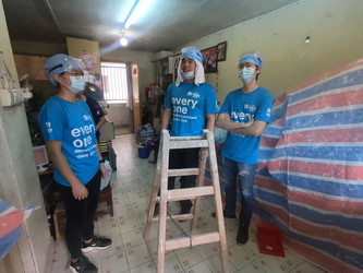 In groups, students work on repairing apartments in Tsuen Wan with Habitat for Humanity