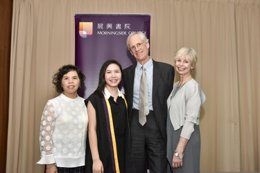 Student and their relative pose with Professor Rawlins and Lalla Ward