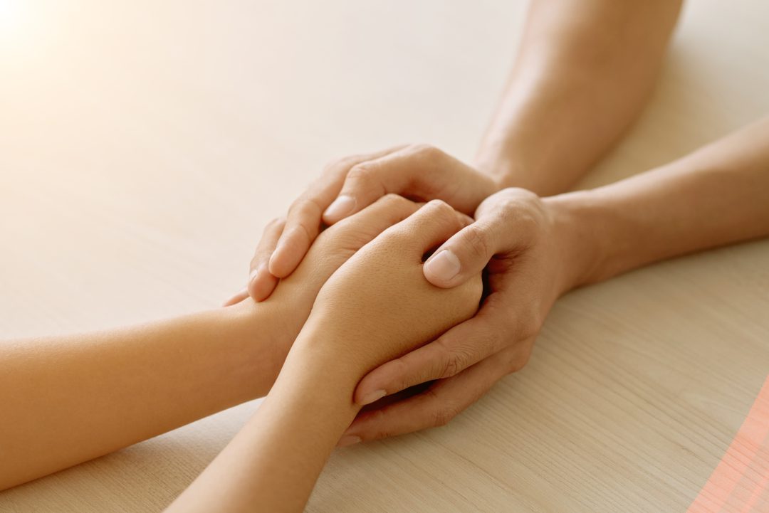 Close-up image of supporting hands of friend.