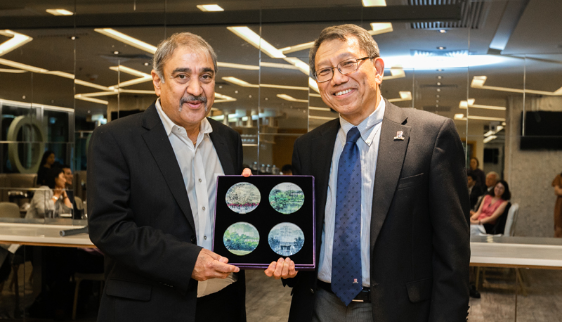 Prof. Rocky S. Tuan presents a gift to UCSD Chancellor Dr. Pradeep K. Khosla (left).