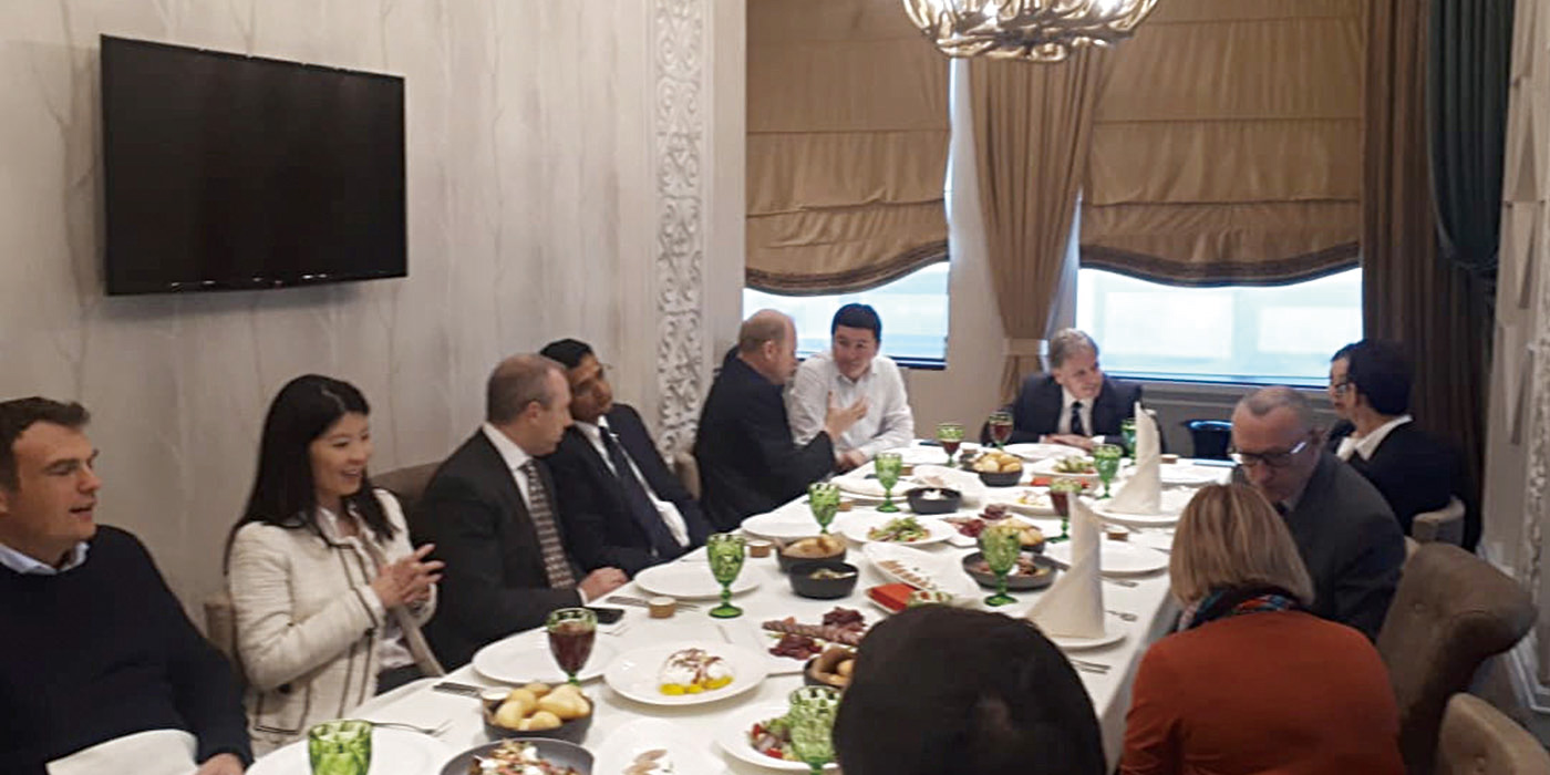 Juni (second from left) at dinner with government officials in Kazakhstan