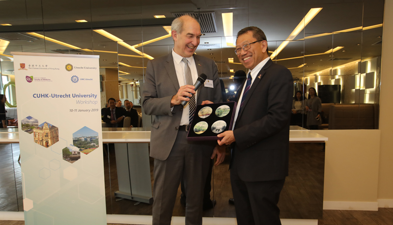 Prof. Rocky S. Tuan presents a souvenir to Prof. Anton Pijpers (left), President of the Executive Board, UU at the closing of the workshop.