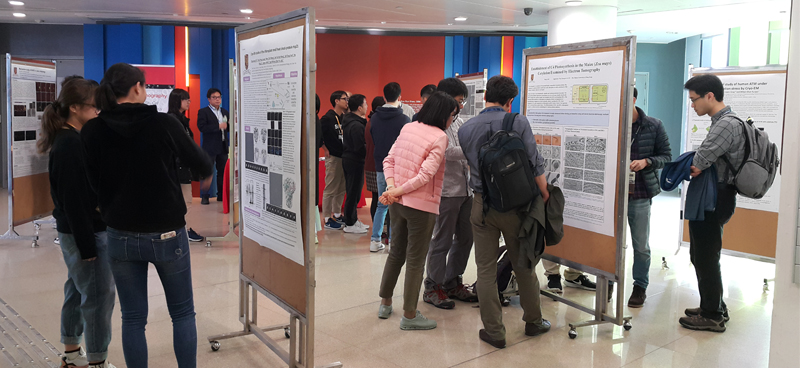 The poster session stimulates interesting discussion among participants.