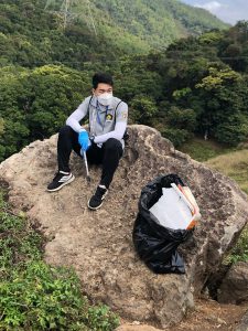 Steve Lau collects garbage in the countryside.