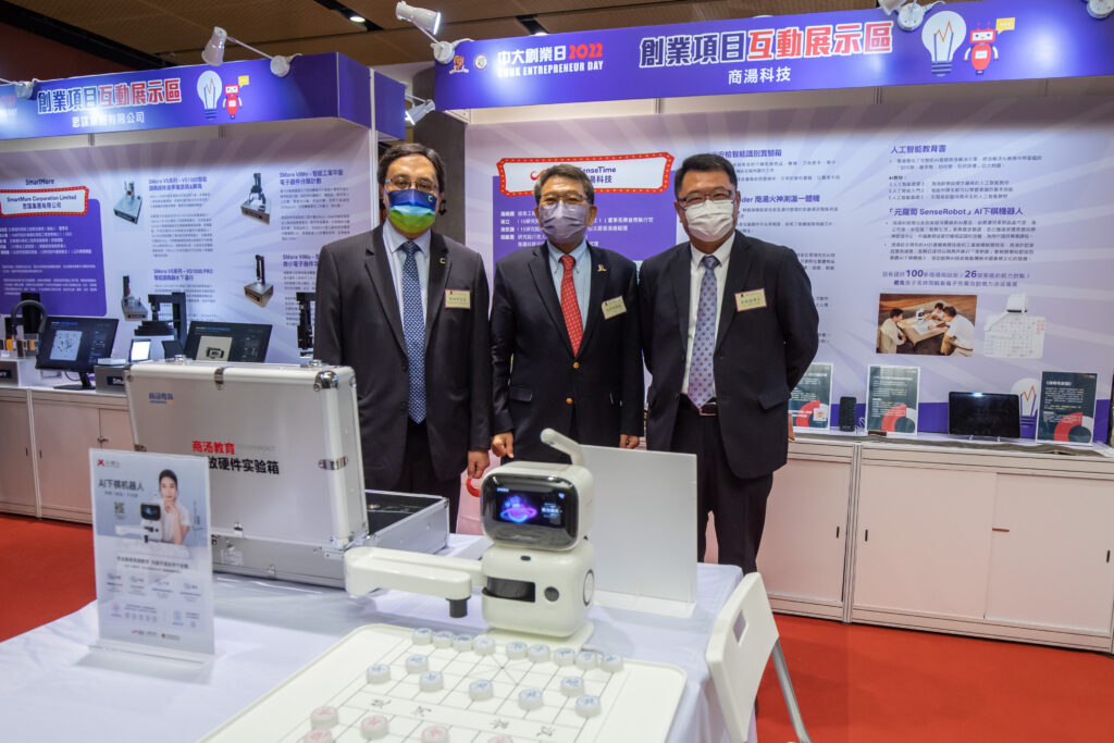 Professor Rocky Tuan (middle), alumni Mr Simon Chan (left) and Dr Sunny Chai visit the exhibition area of SenseTime, CUHK’s first super unicorn.