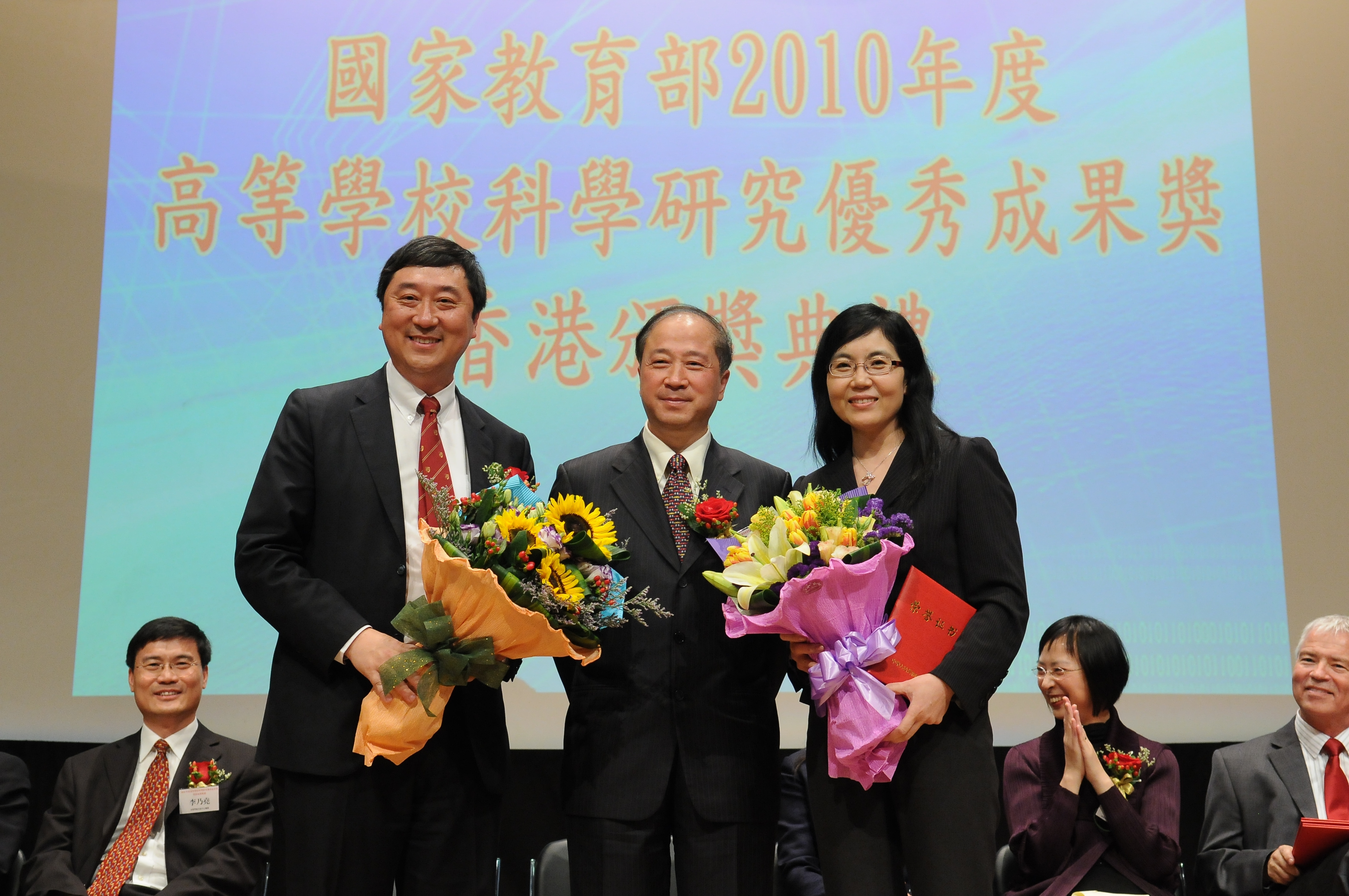 Prof. Joseph J.Y. Sung (left) and Prof. Jun Yu (right) receive their award certificates from Prof. Pan Yonghua, Director General of Education, Science and Technology, Liaison Office of the Central People’s Government in HKSAR.