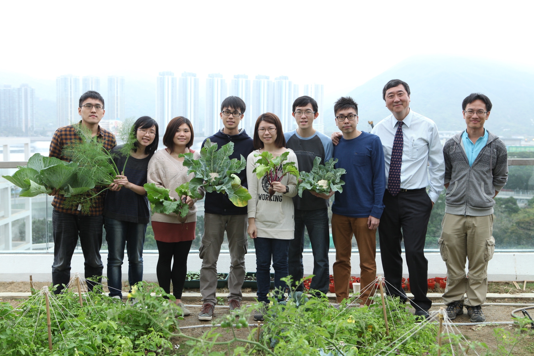 CUHK Architecture students celebrating with Prof. Joseph Sung, the Vice-Chancellor and President, the harvest of the first crop on their rooftop garden on 25 March 2013 as part of their course work on permaculture.