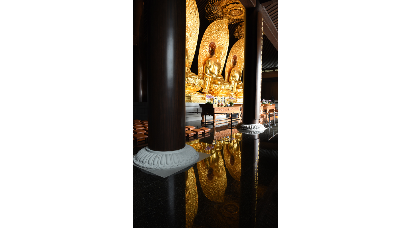 Buddha statues and decorative pillars inside the Main Hall. The pillars are steel encased in African <em>zitan</em> wood and stone (base part)