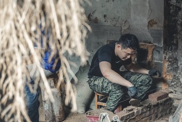 Student laying bricks