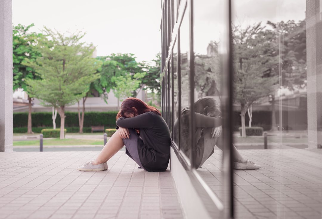 A woman sitting alone and depressed